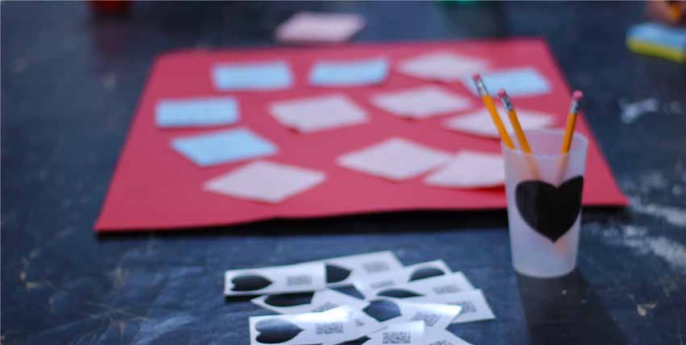 Paper, pencils and cut-outs on the workshop table at Hangar